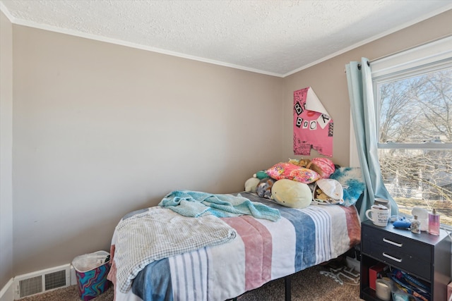 carpeted bedroom featuring visible vents, crown molding, and a textured ceiling