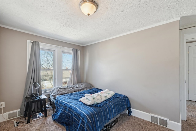 carpeted bedroom featuring baseboards, visible vents, crown molding, and a textured ceiling