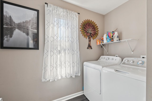 washroom featuring baseboards, washer and dryer, and laundry area