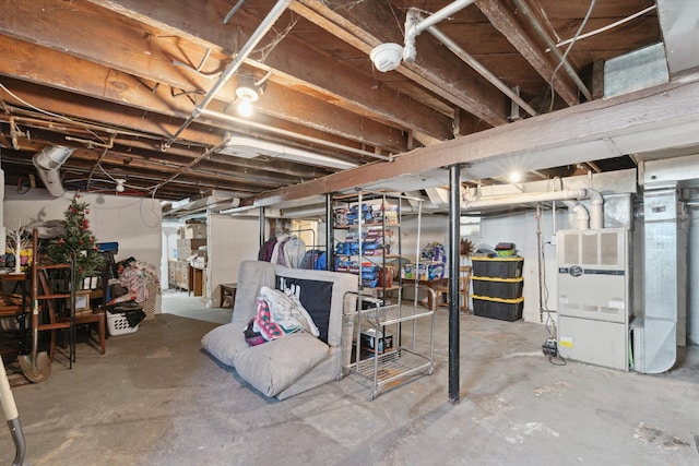 unfinished below grade area featuring heating unit
