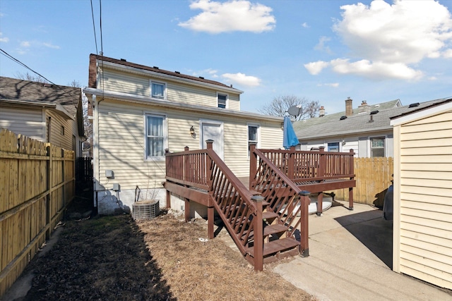 back of property featuring central air condition unit and fence