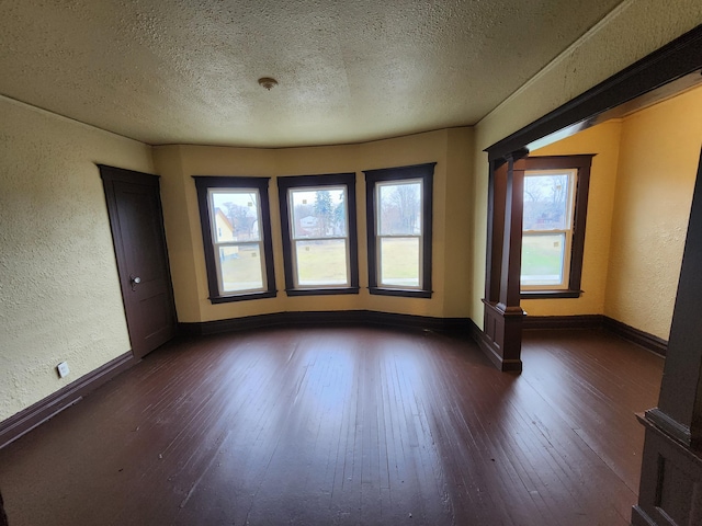 3491 Garland St, Detroit, MI 48214 - empty room with baseboards, dark wood-style flooring, and a textured wall
