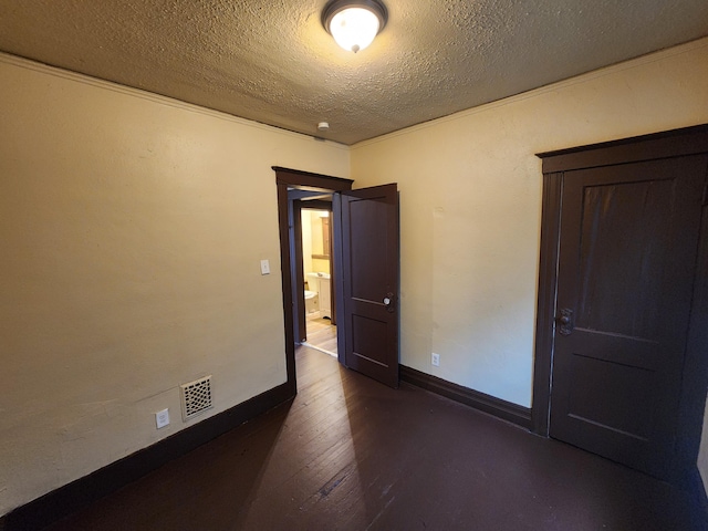 3491 Garland St, Detroit, MI 48214 - unfurnished room featuring visible vents, a textured ceiling, dark wood-type flooring, and baseboards