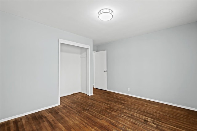 550 Royal Dr, Jackson, MI 49202 - unfurnished bedroom with a closet, baseboards, and dark wood finished floors