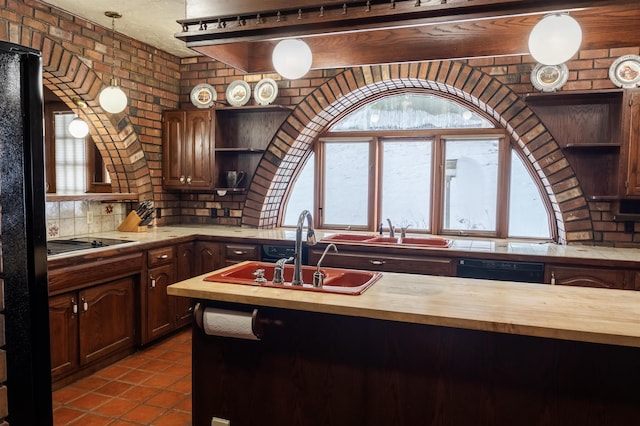 kitchen featuring black appliances, butcher block countertops, open shelves, a sink, and brick wall