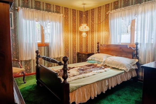 bedroom with carpet flooring and wallpapered walls