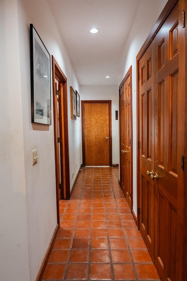 hallway featuring tile patterned floors, recessed lighting, and baseboards