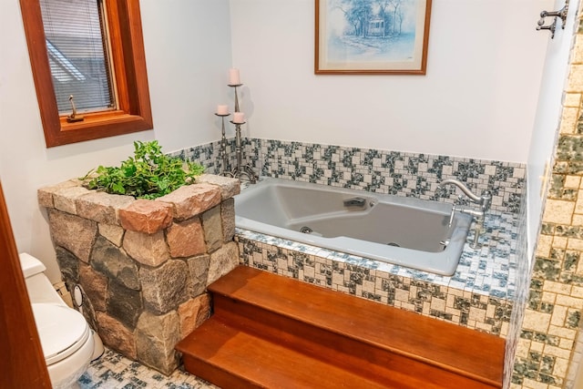 full bath featuring a tub with jets and toilet