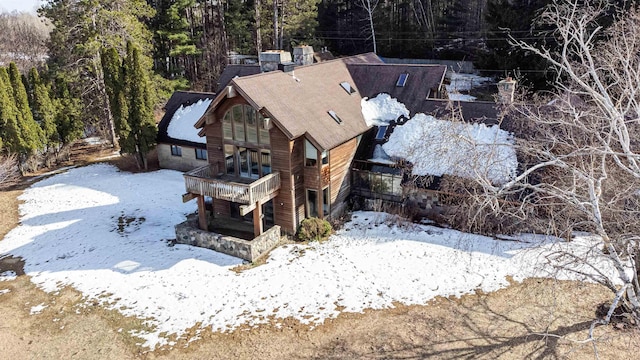 snowy aerial view with a view of trees