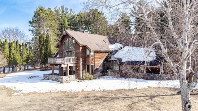 snow covered property featuring a chimney