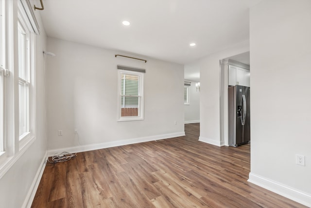 unfurnished room with recessed lighting, baseboards, and wood finished floors