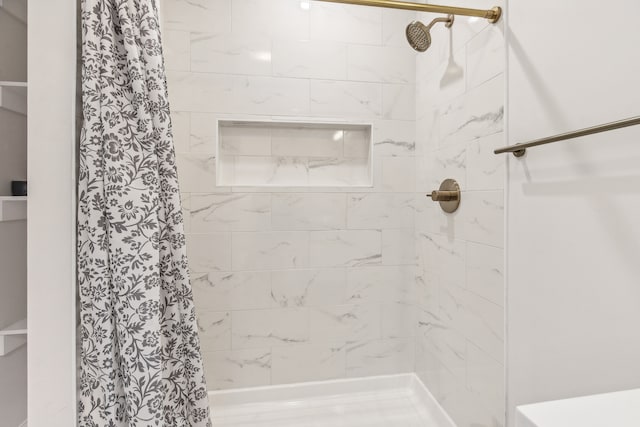 full bathroom with tiled shower