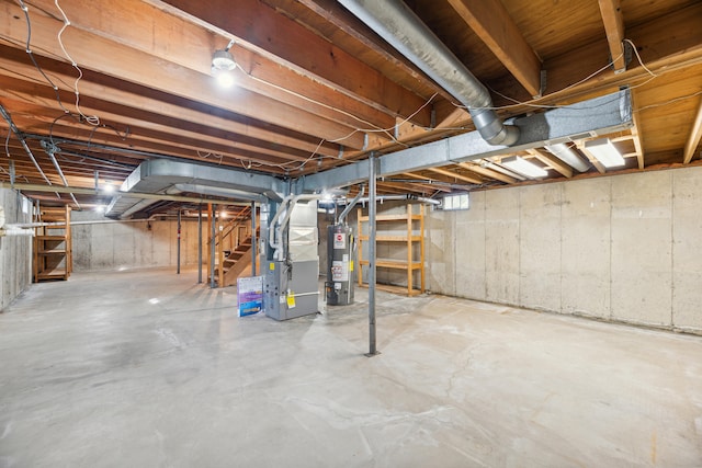 unfinished basement with heating unit, gas water heater, and stairway