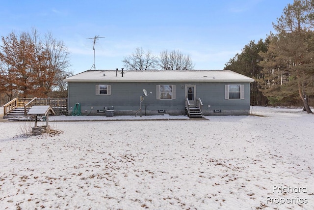 back of house with crawl space and a wooden deck