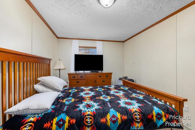 bedroom with a textured ceiling and ornamental molding