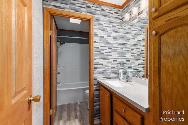 bathroom with shower / washtub combination, toilet, vanity, and wood finished floors
