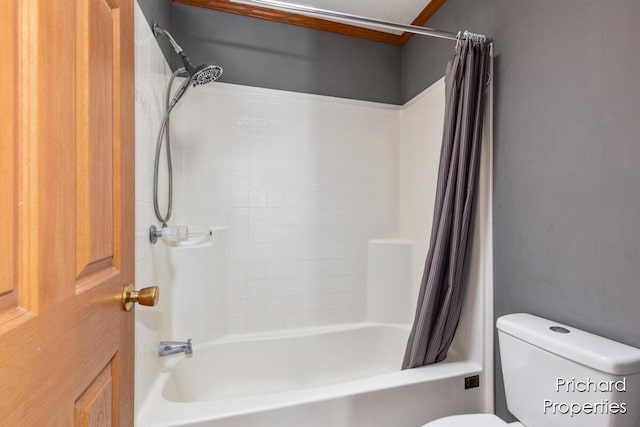 bathroom with toilet and shower / bath combo with shower curtain