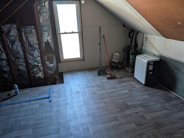 additional living space with lofted ceiling and wood finished floors