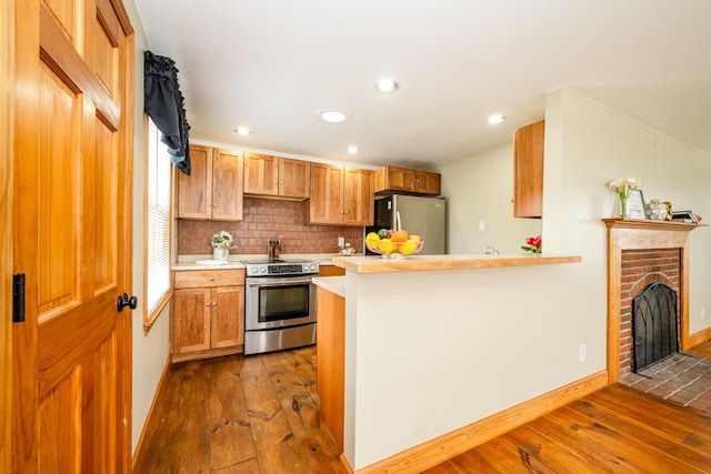 9654 Date Rd, Baroda, MI 49101 - kitchen with dark wood finished floors, backsplash, stainless steel appliances, and light countertops