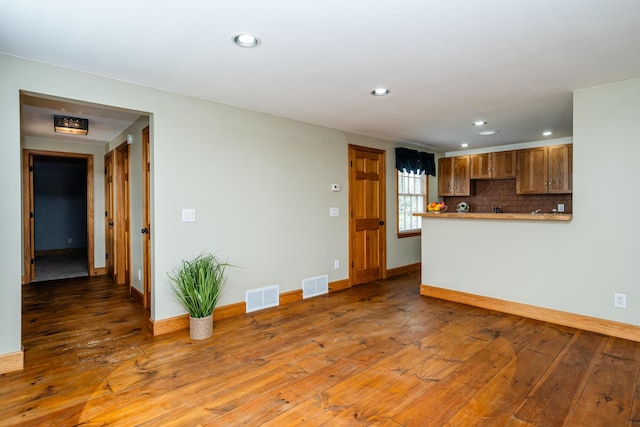 9654 Date Rd, Baroda, MI 49101 - unfurnished living room featuring recessed lighting, visible vents, baseboards, and hardwood / wood-style flooring