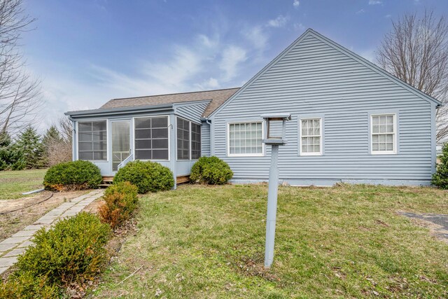 9654 Date Rd, Baroda, MI 49101 - rear view of house featuring a yard, roof with shingles, and a sunroom