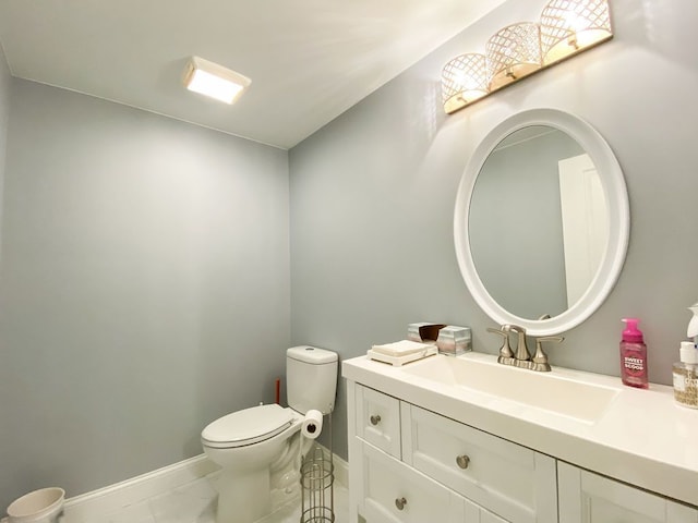 220 S Castell Ave, Rochester, MI 48307 - bathroom featuring vanity, toilet, marble finish floors, and baseboards