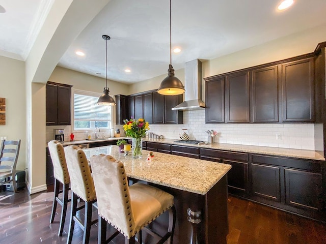 220 S Castell Ave, Rochester, MI 48307 - kitchen featuring wall chimney exhaust hood, a sink, a center island, a kitchen bar, and dark brown cabinetry