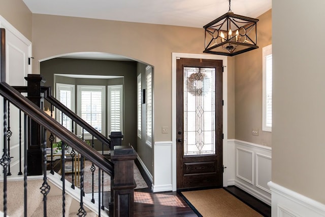 220 S Castell Ave, Rochester, MI 48307 - entryway featuring healthy amount of natural light, arched walkways, a wainscoted wall, and stairway