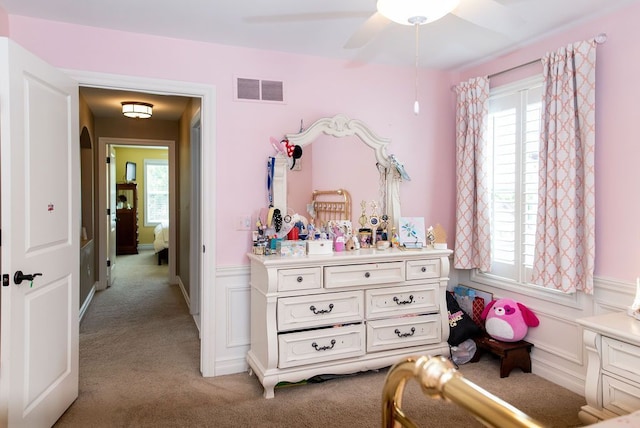 220 S Castell Ave, Rochester, MI 48307 - bedroom with light colored carpet, wainscoting, a decorative wall, and a ceiling fan