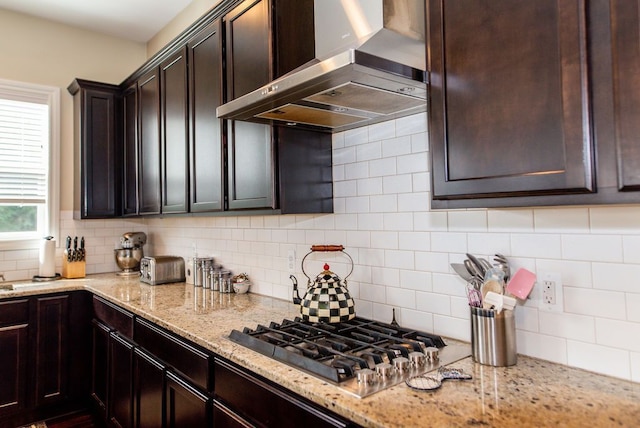 220 S Castell Ave, Rochester, MI 48307 - kitchen featuring wall chimney exhaust hood, stainless steel gas cooktop, dark brown cabinetry, and tasteful backsplash