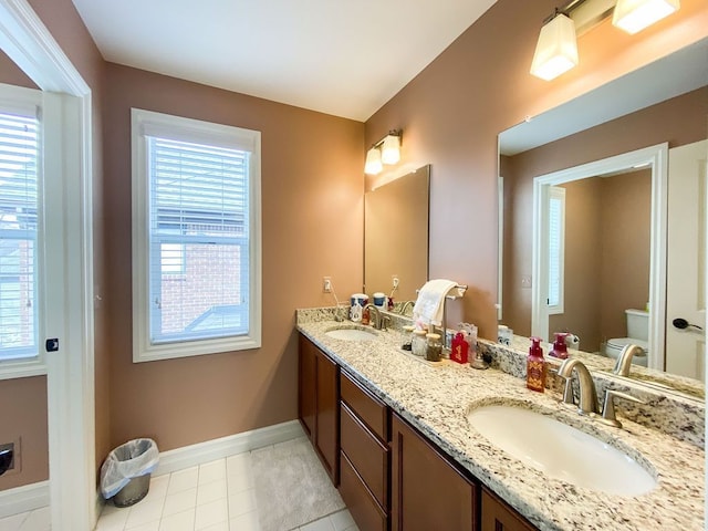 220 S Castell Ave, Rochester, MI 48307 - bathroom with toilet, plenty of natural light, double vanity, and baseboards