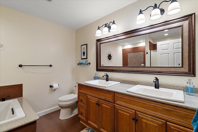 4144 Ridge Rd Unit 16, Stevensville, MI 49127 - full bath featuring double vanity, baseboards, toilet, wood finished floors, and tiled shower