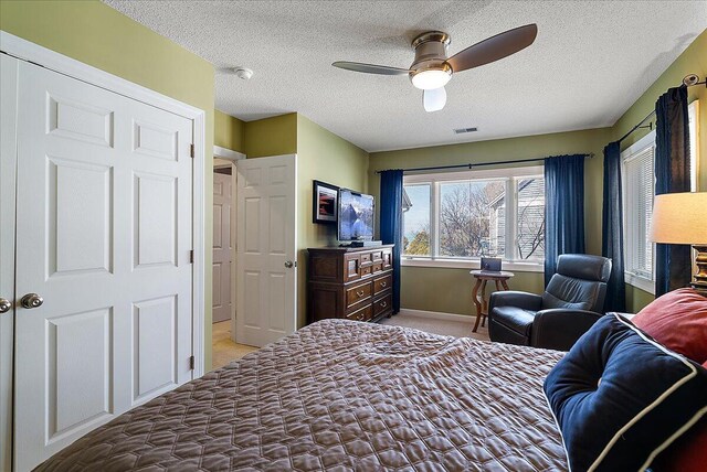 4144 Ridge Rd Unit 16, Stevensville, MI 49127 - bedroom with light carpet, a textured ceiling, baseboards, and ceiling fan