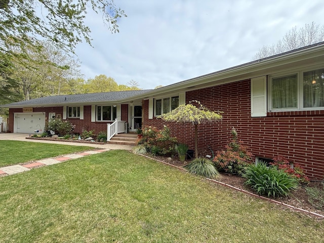 7298 W M-116, Ludington, MI 49431 - ranch-style home with brick siding, a garage, a front yard, and concrete driveway