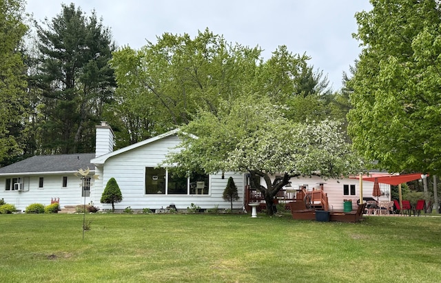 7298 W M-116, Ludington, MI 49431 - view of front of home with a wooden deck, a front yard, and a chimney