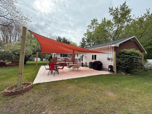 7298 W M-116, Ludington, MI 49431 - rear view of property featuring a patio and a lawn