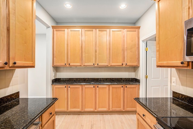 50128 Bethesda, Shelby Twp, MI 48317 - kitchen with tasteful backsplash, recessed lighting, stainless steel microwave, dark stone counters, and light wood finished floors