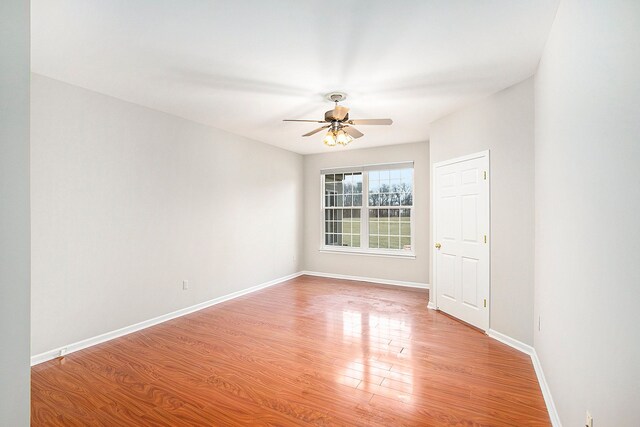 50128 Bethesda, Shelby Twp, MI 48317 - spare room with a ceiling fan, baseboards, and wood finished floors
