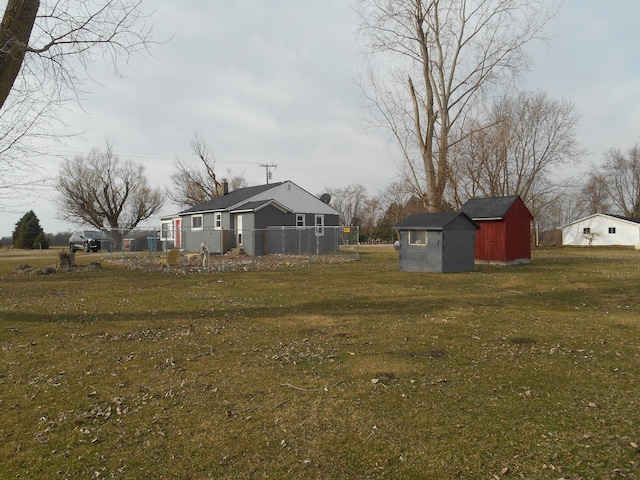 5972 Birch Run Rd, Millington, MI 48746 - view of yard with fence, an outdoor structure, and a storage unit