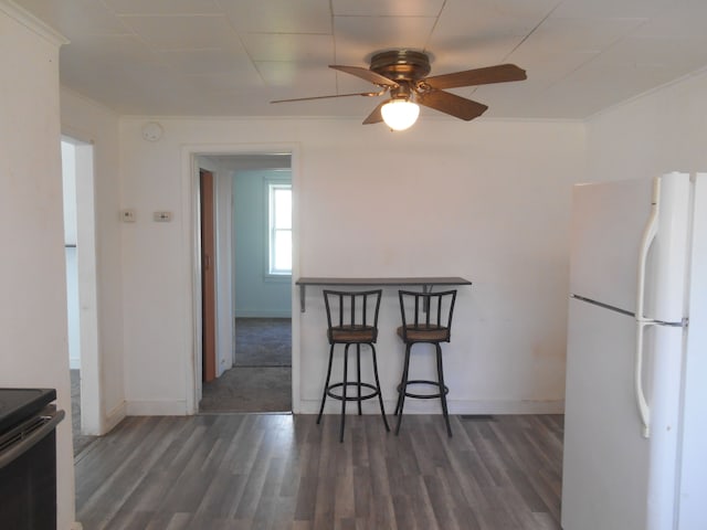 5972 Birch Run Rd, Millington, MI 48746 - kitchen with freestanding refrigerator, a ceiling fan, baseboards, and wood finished floors