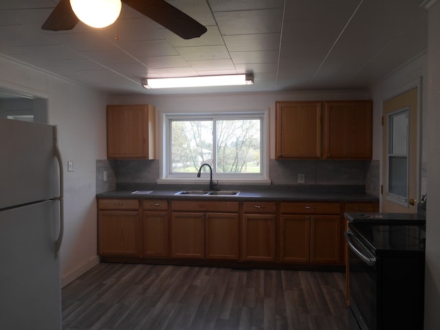 5972 Birch Run Rd, Millington, MI 48746 - kitchen featuring freestanding refrigerator, dark countertops, black electric range, tasteful backsplash, and a sink