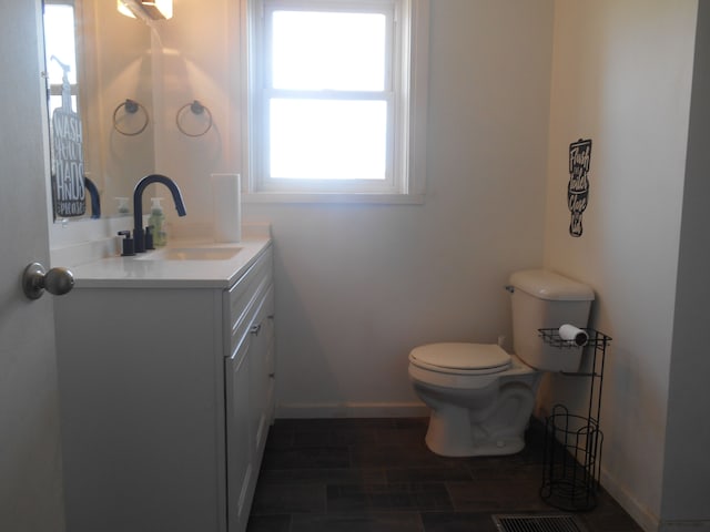5972 Birch Run Rd, Millington, MI 48746 - half bath featuring vanity, baseboards, wood finish floors, and toilet