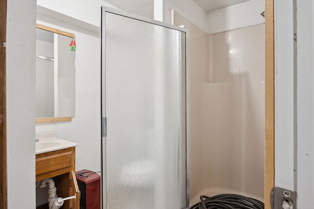 bathroom with a shower stall and vanity