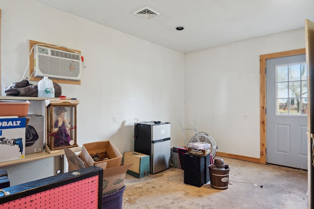 interior space with a wall unit AC and visible vents