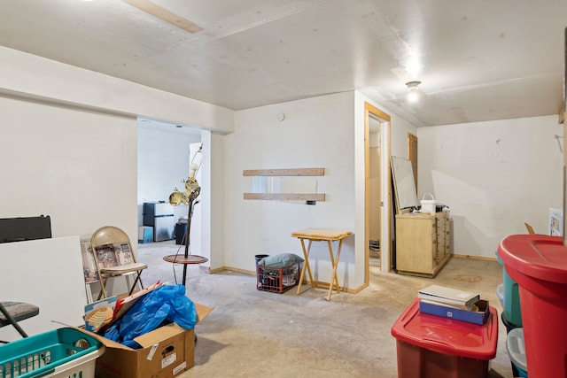game room with unfinished concrete floors and baseboards