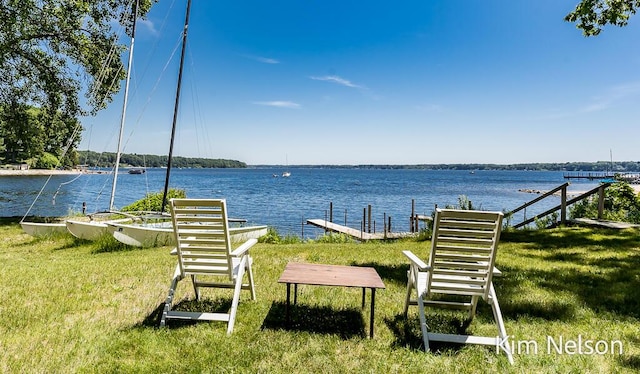 6195 Murray Rd, Whitehall, MI 49461 - surrounding community with a water view, a lawn, and a boat dock