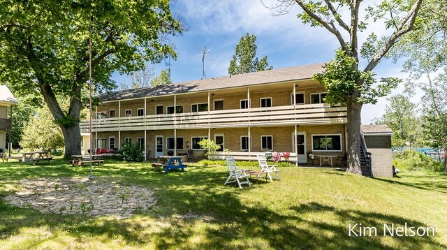 6195 Murray Rd, Whitehall, MI 49461 - rear view of property featuring a yard and a balcony