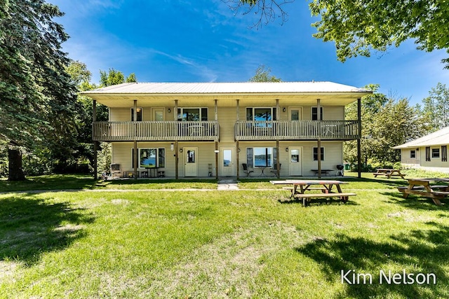 6195 Murray Rd, Whitehall, MI 49461 - rear view of property with metal roof, a yard, and a balcony