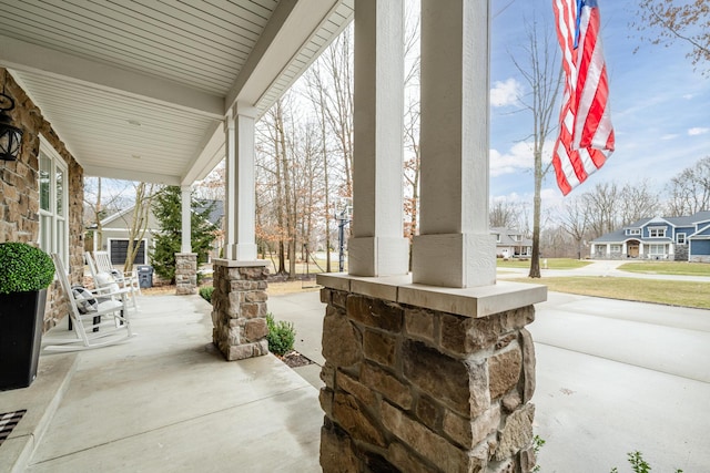 view of patio featuring a porch and a residential view