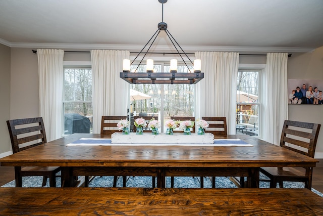 unfurnished dining area featuring an inviting chandelier and crown molding
